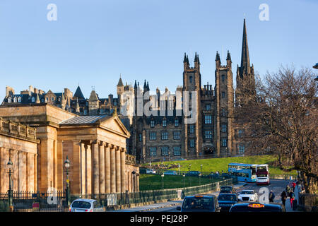 Edinburgh, United Kingdom – March 20,  2018 : People walking while busses and cars and taxis are in the street in front of the National gallery Stock Photo