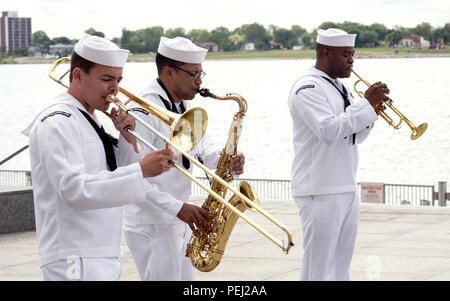 150826-N-CI175-124 DETROIT, Mich. (Aug. 26, 2015) Musicians assigned to the Navy Band Great Lakes Brass Band perform along Detroit’s downtown RiverWalk as part of Detroit Navy Week. Navy Weeks focus a variety of assets, equipment and personnel on a single city for a week-long series of engagements designed to bring America's Navy closer to the people it protects, in cities that don't have a large naval presence. (U.S. Navy photo by Mass Communication Specialist 1st Class Jon Rasmussen/Released) Stock Photo