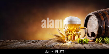 Beer Mug With Wheat And Hops In Cellar With Barrel Stock Photo