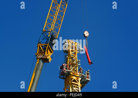 construction workers assembling giant crane on building site in leeds yorkshire united kingdom