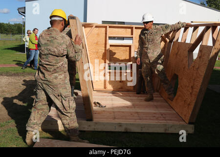 Soldiers assigned to 500th Engineer Company, 15th Engineer Battalion, 18th Military Police Brigade, raise walls on a playhouse at the Vinni Family Home, Vinni, Estonia, as part of Operation Atlantic Resolve.  Operation Atlantic Resolve is a multinational interoperability exercise which combines the efforts and dedication of all NATO allies involved to provide stability in the region. (U.S. Army photo by Spc. Jacqueline Dowland, 13th Public Affairs Detachment) Stock Photo