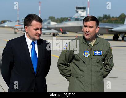 Robert Kupiecki, Polish deputy minister of national defence, left, and U.S. Air Force Maj. Gen. Christopher Bence, 3rd Air Force and 17th Expeditionary Air Force vice commander, right, speak during a press conference on the flightline at Lask Air Base, Poland, Aug. 31, 2015. The two highlighted the U.S. Air Force F-22 Raptor training deployment to Europe as part of the European Reassurance Initiative. The deployment is also part of ensuring 5th generation fighters can deploy to European bases and other NATO installations. The F-22s are deployed from the 95th Fighter Squadron at Tyndall Air For Stock Photo