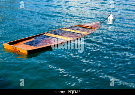 Small boat is sinking in the sea Stock Photo