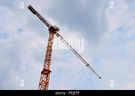 Looking up at single high rise tower construction crane Stock Photo