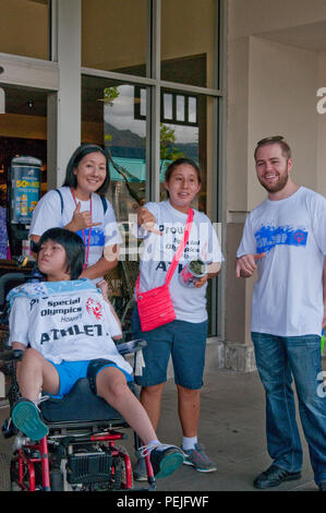 (Left to right:) Sherilynn Yoshida, a James B. Castle High School freshman, Jill Nagamine, a Special Olympics Hawaii volunteer, Kendra Winters, a James B. Castle High School junior, and Andrew Distad, a James B. Castle High School teacher, volunteer on the first day of the annual fundraiser Cop on Top at Kaneohe Bay Shopping Center, Aug. 27, 2015. All proceeds raised benefit Special Olympics Hawaii to provide year-round sports training and competition opportunities to more than 3,900 athletes across the state each year. Supporting events like Cop on Top help improve relationships between the M Stock Photo