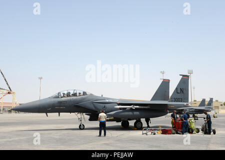 U.S. Air Force maintainers prepared to perform post-flight maintenance on an F-15E Strike Eagle assigned to the 380th Expeditionary Air Wing at a Southwest Asia location on August 31, 2015. The F-15E is a twin-engine multirole fighter powered by two Pratt & Whitney F100-PW-229 engines. Maintenance included inspections, refueling, avionics testing, and weapons system checks after supporting Operation Inherent Resolve, ensuring readiness for combat and subsequent missions. Stock Photo