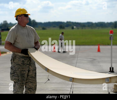 Senior Master Sgt. Charlie Sweetin, a communications infrastructure systems specialist with the 147th Maintenance Group, 147th Reconnaissance Wing, Texas Air National Guard, based at Ellington Field Joint Reserve Base in Houston, assembles a satellite Aug. 31, 2015, at Lielvarde Air Base, Latvia. The maintainers mobilized with other members of the wing to the Baltic nation where they deployed an entire MQ-1B Predator package, launching and recovering the first large-scale remotely piloted aircraft in Latvia. (Air National Guard photo by 1st Lt. Alicia Lacy/Released) Stock Photo