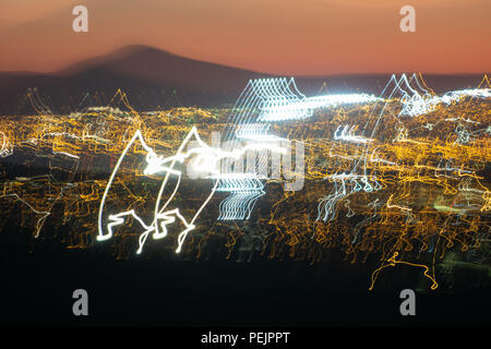 Urban abstract city lights in motion blur under red sunset sky Stock Photo