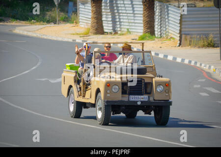 WINDHOEK NAMIBIA - MAY 10 2018; Group tourists being driven through city in open 4wd with guide. Stock Photo