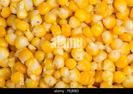 Culinary background of boiled maize grains. Close-up of a beautiful yellow heap of sweet corn seeds. Tasty organic vegetable. Healthy vegetarian food. Stock Photo