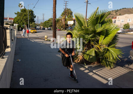 Boy on scooter on Figueroa Street in the Mount Washington neighborhood of Los Angeles, California. Stock Photo