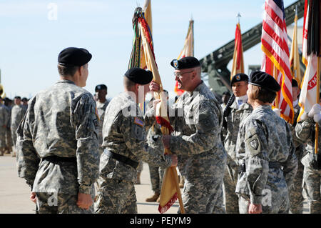 Maj. Gen. Mark Palzer, incoming commanding general of the 79th Sustainment Support Command, passes the 79th SSC’s guidon to Command Sgt. Maj. Ted Copeland, command sergeant major of the 79th SSC, during the change of command ceremony at Joint Forces Training Base, Los Alamitos, Calif., Dec. 5, 2015. (U.S. Army photo by Spc. Heather Doppke/released) Stock Photo