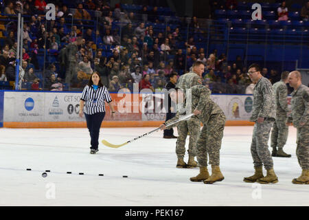 Army competitors take part in the Best Shot Competition of the Arctic Warrior Challenge during the first intermission of the 21st Annual Army vs Air Force hockey game Saturday, Dec. 5, at the Carlson Center in Fairbanks, Alaska. (U.S. Army photo/John Pennell) Stock Photo