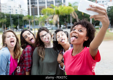 Group of girlfriends taking crazy selfie outdoors in the summer in the city Stock Photo