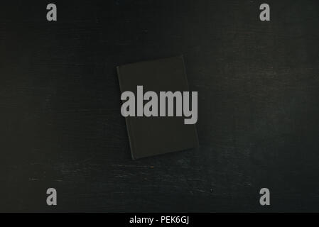 Top view flat lay black notebook on dark background, stylish diary or textbook with mock up copy space Stock Photo