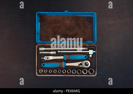 Old used socket tool box with accessories top view - ratchets with hexagon sockets, extension bars and reducers Stock Photo