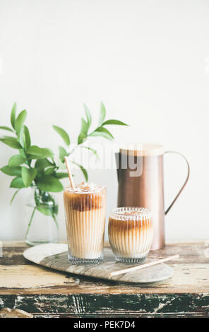 Iced coffee drink in tall glasses with milk, vertical composition Stock Photo