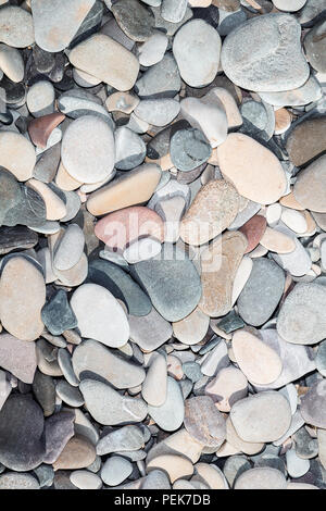 Naturally polished rock pebbles background. Sea stone wallpaper Stock Photo