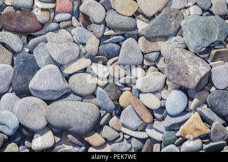Naturally polished rock pebbles background. Sea stone wallpaper Stock Photo