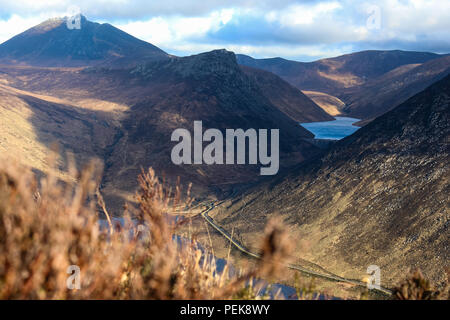 Ben Crom reservoir, dam and Ben Crom Mountain (in shadow). Slieve Bearnagh top left. Silent Valley path (bottom right), Mourne Mountains. Stock Photo