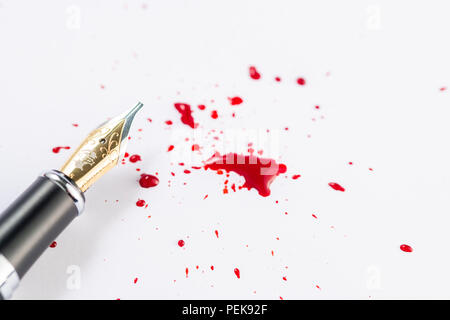 Splatter of red fountain pen ink on an isolated white background Stock Photo