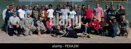 Volunteers from Better Opportunities for Single Soldiers, Army Community Service, and the Fort Bliss Garrison Command Sgt. Maj. Bobby J. Breeden, pose for a group photo during Trees for Troops at Biggs Park, Dec. 11, 2015. Trees for Troops is a non-profit organization that provides free Christmas trees to military families in the United States and overseas. (U.S. Army photo by Sgt. Jessica R. Littlejohn, 24th Press Camp Headquarters/Released) Stock Photo