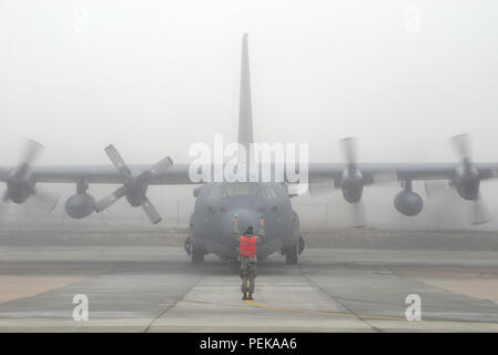 The HC-130 Hercules of the 102nd Rescue Squadron, 106th Rescue Wing, was positioned on the flightline at Francis S. Gabreski Air National Guard Base on December 14, 2015, during routine maintenance checks. This aircraft, equipped with four Allison T56-A-15 turboprop engines, is used by the U.S. Air National Guard for combat search and rescue, pararescue, and personnel recovery operations. The maintenance event occurred under heavy fog conditions, reflecting standard operational procedures for aircraft safety and mission readiness. Stock Photo