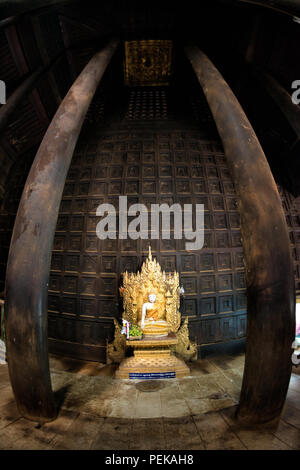 INWA (AVA), Myanmar — The main altar and shrine of Bagaya Monastery in Inwa, Myanmar. Also known as Bagaya Kyaung, the monastery was built in 1834 during the reign of King Bagyidaw. It is constructed entirely of teak, with 267 giant teak posts, the largest of which is 60 feet high and 9 feet in circumference. It is located in the old royal capital region of Inwa (Ava), not far from Mandalay. Stock Photo