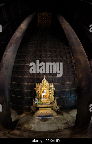 INWA (AVA), Myanmar — The main altar and shrine of Bagaya Monastery in Inwa, Myanmar. Also known as Bagaya Kyaung, the monastery was built in 1834 during the reign of King Bagyidaw. It is constructed entirely of teak, with 267 giant teak posts, the largest of which is 60 feet high and 9 feet in circumference. It is located in the old royal capital region of Inwa (Ava), not far from Mandalay. Stock Photo