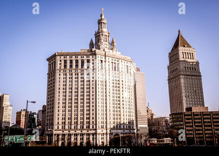 Landscape view of the The David N. Dinkins Manhattan Municipal Building,from the Brooklyn Bridge, in Manhattan, New York, with blue sky in the back Stock Photo