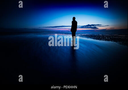 Another Place is a piece of modern sculpture by Sir Antony Gormley located at Crosby Beach in Liverpool City Region, England Stock Photo