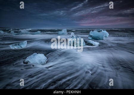 Glacial Ice washed ashore on the beach at Jokulsarlon Black Sand Beach also known as Breidamerkursandur, Iceland