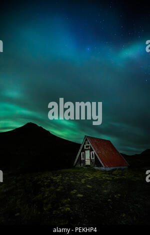 Emergency Mountain Hut / Shelter with the Northern Lights & Aurora Borealis, Snaefellsnes Peninsula, Iceland Stock Photo