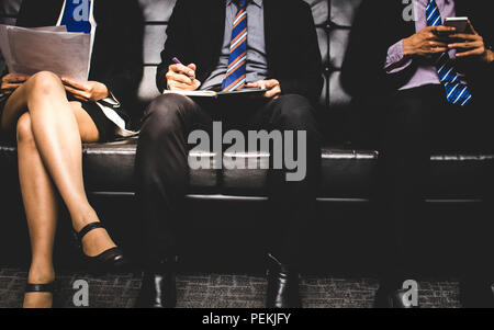 stressful people group sitting and waiting to interview for a job on sofa. Stock Photo