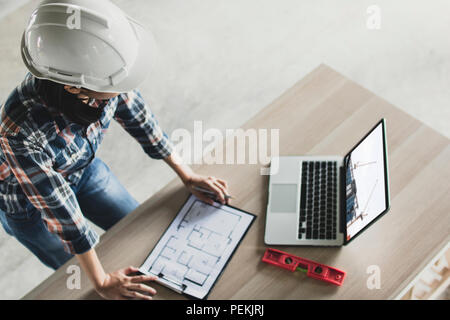 top view of portrait of architect looking picture at laptop about progression of building construction and following working process at site consturct Stock Photo