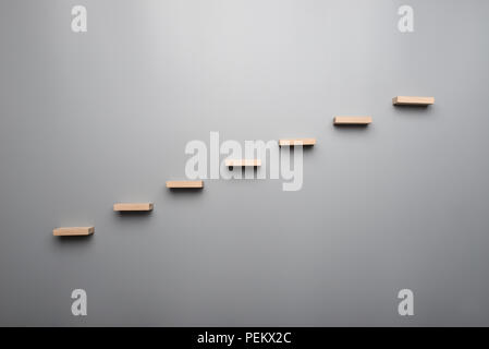 Graph or wooden steps on grey background in a concept of vision on grey background. Stock Photo