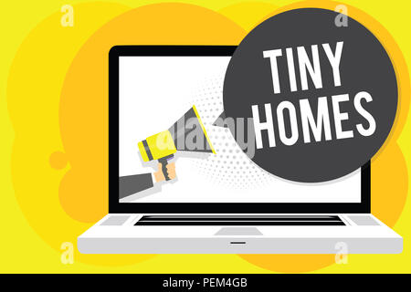 Conceptual hand writing showing Tiny Homes. Business photo showcasing houses contain one room only or two and small entrance Cheap Man holding Megapho Stock Photo