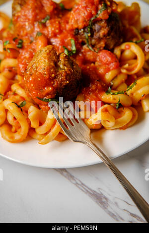 Spaghetti and meatballs with     noodles and chopped fresh basil Stock Photo