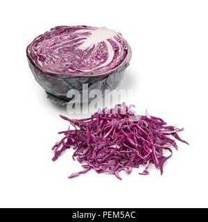 Heap of fresh raw shredded red cabbage and a half one in the background Stock Photo