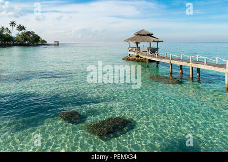 Wooden pier between sunset in Phuket, Thailand. Summer, Travel, Vacation and Holiday concept. Stock Photo