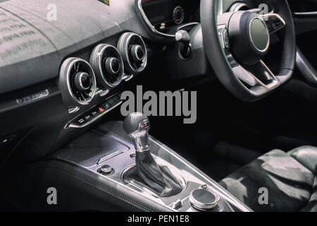 Luxury of car interior at transmission shift gear area. Modern car interior, gearstick radio and cup holder. Stock Photo