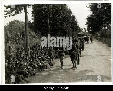 London Territorials resting on the march [Estaires La Bass u00e9e Road, France]. Photographer  H. D. Girdwood. Stock Photo