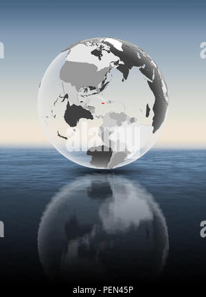 Jamaica in red on translucent globe floating above water. 3D illustration. Stock Photo
