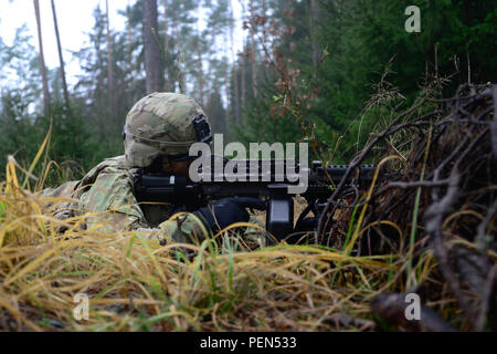 A Soldier assigned to the 15th Engineer Battalion, 18th Military Police Brigade, provides security during a live-fire convoy exercise at the 7th Joint Multinational Training Command’s Grafenwoehr Training Area, Grafenwoehr, Germany, Dec. 15, 2015.  This exercise is designed to prepare soldiers to navigate through rough terrain while under fire. (U.S. Army photo by PFC Emily Houdershieldt/released) Stock Photo