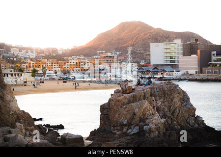 CABO SAN LUCAS, BCS, MEXICO - FEB 02, 2017: Group of youth spending the late afternoon by the public beach near the marina in Cabo San Lucas. Stock Photo