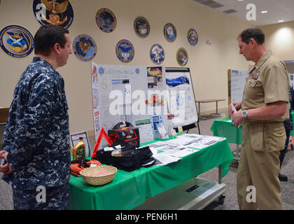 Right, Rear Adm. Matthew Kohler, commander Navy Information Dominance Forces tours the fall/winter safety fair held Dec. 10. The fair, held by Navy Information Dominance Forces, Navy Network Warfare Command and Navy Cyber Defense Operations Command kicked off the holiday season to reiterate the importance for Sailors and civilian employees to make good decisions and to stay safe for the winter season. More than 500 Sailors and civilian employees attended the event, which was organized by the command's safety office.  Various topics that were covered included: electrical and ladder safety, moto Stock Photo