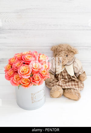 Roses in a round box and a bear. Romantic gift. Roses in a Hat Box Stock Photo