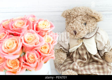 Roses in a round box and a bear. Romantic gift. Roses in a Hat Box Stock Photo