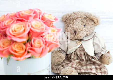 Roses in a round box and a bear. Romantic gift. Roses in a Hat Box Stock Photo