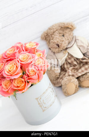 Roses in a round box and a bear. Romantic gift. Roses in a Hat Box Stock Photo